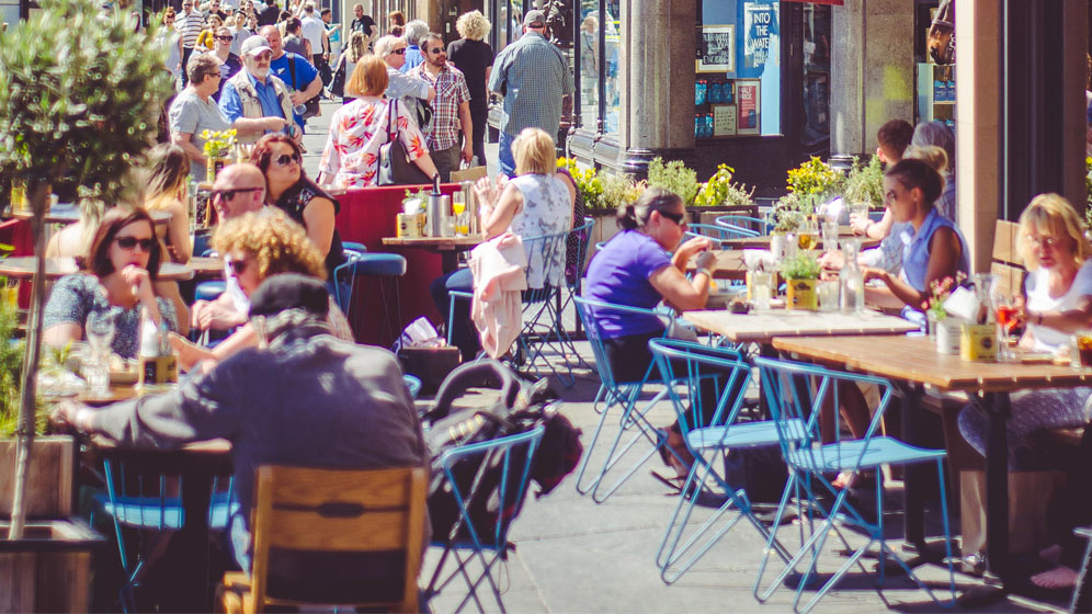 People dining outside enjoying the sunshine